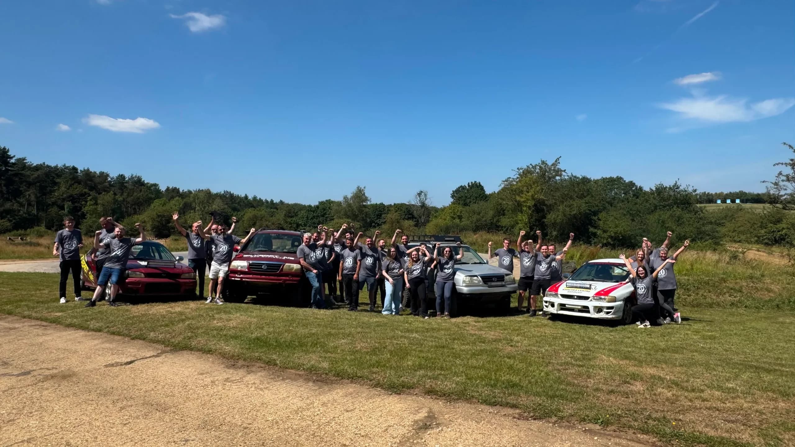 Team photo of TopGrass employees at a rally car training day